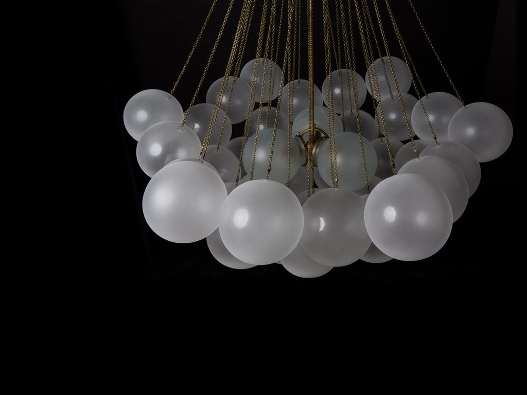 Opaque glass pendant with spherical distribution and metal parts