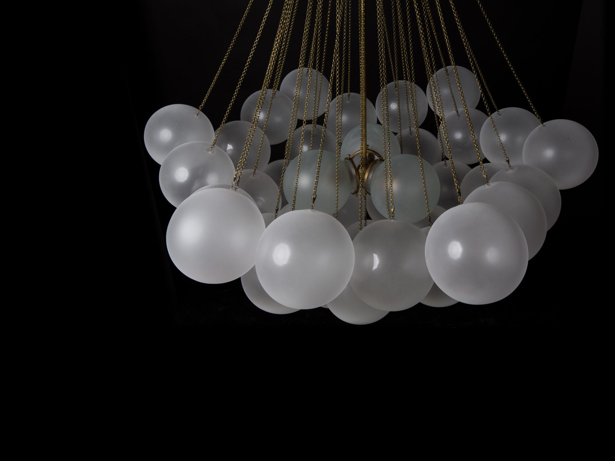 Opaque glass pendant with spherical distribution and metal parts