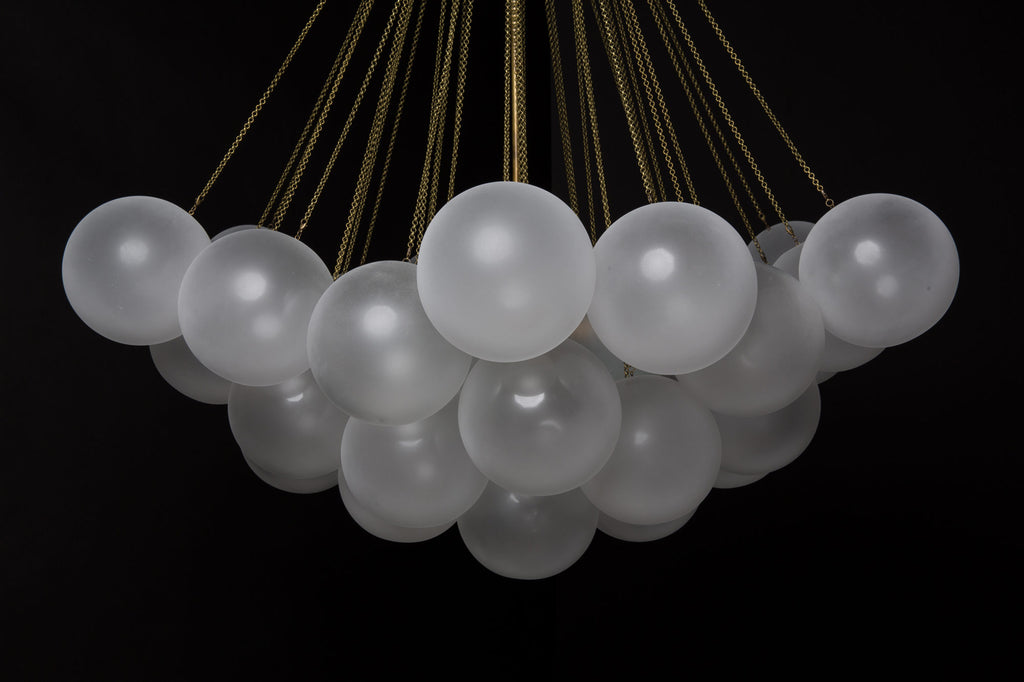 Opaque glass pendant with spherical distribution and metal parts