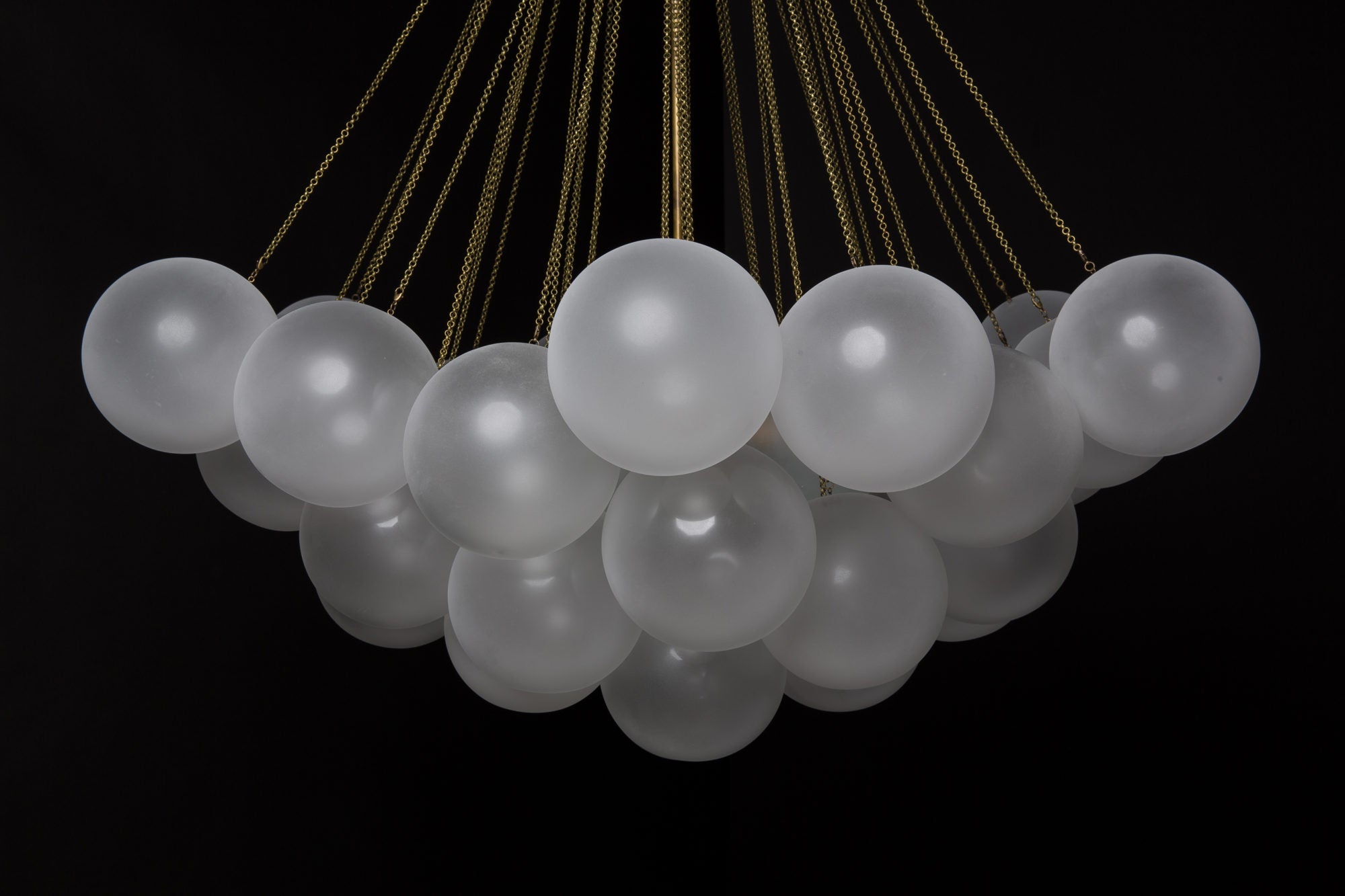 Opaque glass pendant with spherical distribution and metal parts